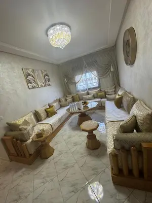 a large living room with couches and a chandelier at Appartement Casablanca près de la mer in Dar Bouazza