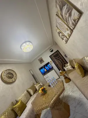 a living room with a couch and a table at Appartement Casablanca près de la mer in Dar Bouazza