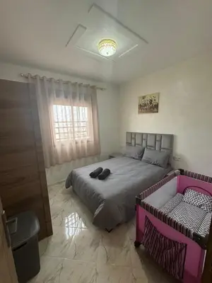 a bedroom with a large bed and a window at Appartement Casablanca près de la mer in Dar Bouazza
