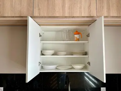a cupboard with bowls and plates inside of it at Luxury Oasis Apartment -Rooftop Pool & Home Cinema in Casablanca