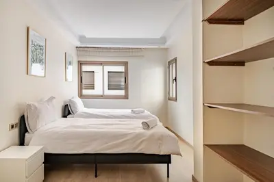 a small bedroom with a bed and a window at Spacious & Central 3 bedrooms-Casablanca Center in Casablanca