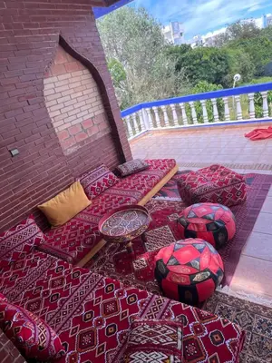 a group of pillows and blankets on a patio at Chez Bouchra in Mansouria