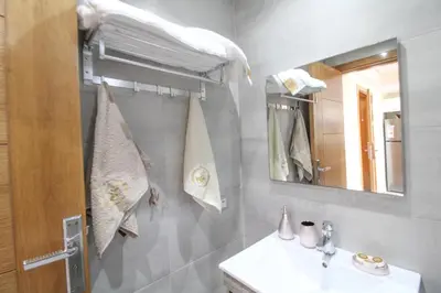 a bathroom with a sink and a mirror at Riviera Escape - Appart Neuf Climatisé avec Balcon à Maarif Anfa in Casablanca