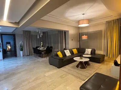 a living room with a couch and a table at Urban square - comfortable, sunny, and fully equipped in Casablanca