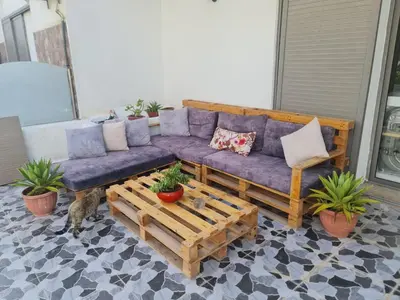 a purple couch on a patio with potted plants at Résidence marbella mansouria in Mansouria