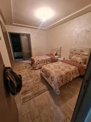 a bedroom with three beds in a room at Résidence marbella mansouria in Mansouria