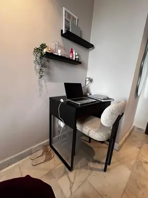 a desk with a laptop and a chair in a room at Le Balcon du Port in Casablanca
