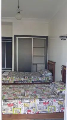 a bedroom with two twin beds and a closet at La Siesta Beach Resort in Mohammedia