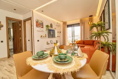 a living room with a table and chairs at AS29 studio luxueux au centre casablanca Tramway Parking free in Casablanca