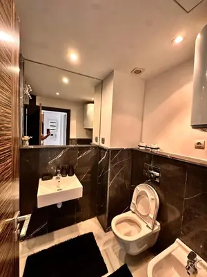 a bathroom with a toilet and a sink at Cozy apartment near the sea in Casablanca
