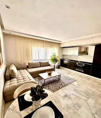 a living room with a couch and a table at Cozy apartment near the sea in Casablanca