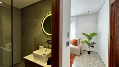 a bathroom with a sink and a mirror at Rooftop Pool Studio - By AppartAli in Casablanca