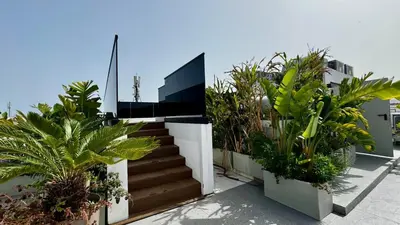 a stairway with plants on the side of a building at Pool in the Sky - By AppartAli in Casablanca