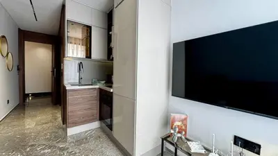 a kitchen with a large flat screen tv on a wall at Pool in the Sky - By AppartAli in Casablanca