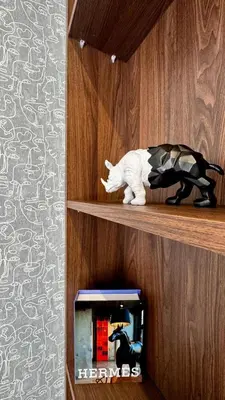 a cat sitting on a shelf next to a clock at Pool in the Sky - By AppartAli in Casablanca