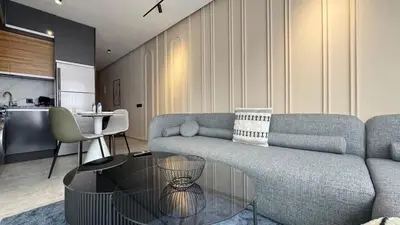 a living room with a couch and a table at The CFC View - By AppartAli in Casablanca