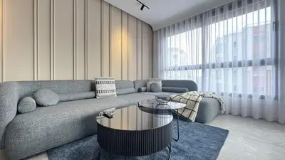 a living room with a couch and a table at The CFC View - By AppartAli in Casablanca