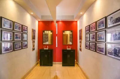 a hallway with red walls and pictures on the walls at Villa Paquet - Quartier Art Déco in Casablanca