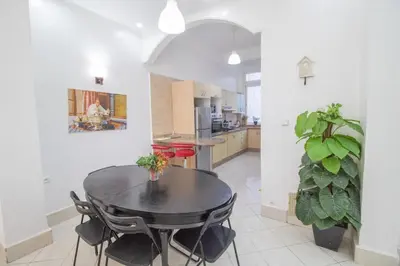 a dining room with a table and a kitchen at Spacious Family Apartment in Casablanca in Casablanca