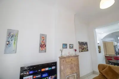 a living room with a tv and some pictures on the wall at Spacious Family Apartment in Casablanca in Casablanca