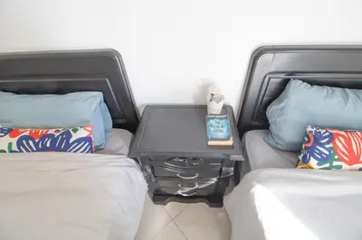 a room with two beds and a table between them at Spacious Family Apartment in Casablanca in Casablanca