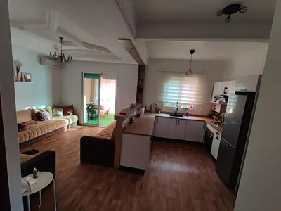 a kitchen and a living room with a couch at Ricoflores Mansouria in Mansouria