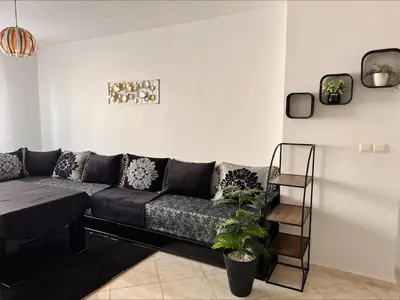a living room with a couch in a room at BOUZNIKA PLAGe in Bouznika