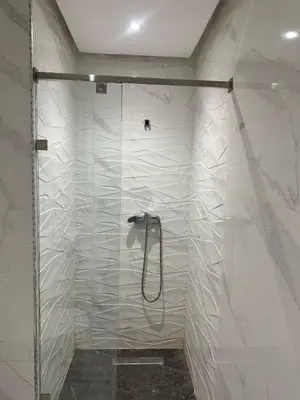 a shower with a glass door in a bathroom at Appartement à Témara - Élégance et confort in Temara