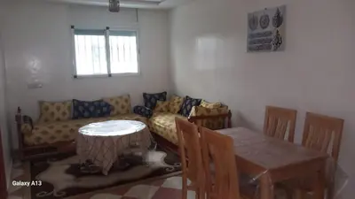 a living room with a table and a couch at Le Refuge in Temara