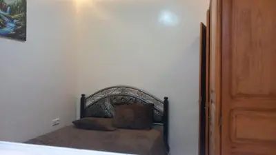 a bed with two pillows on it in a room at Le Refuge in Temara