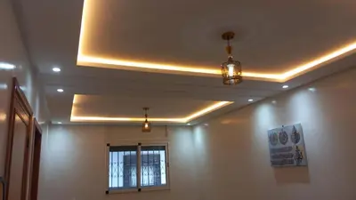 a ceiling with lights and a window in a room at Le Refuge in Temara