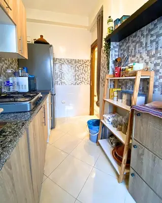 a kitchen with a refrigerator and a counter top at Appartement Calme à Mohammadia - Séjour Agréable in Mohammedia