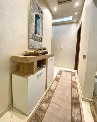 a kitchen with white cabinets and a counter at Appartement Calme à Mohammadia - Séjour Agréable in Mohammedia