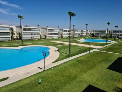 an image of an apartment complex with two pools at appartement ola blanca 2 in Dar Hamida