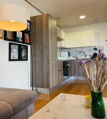 a living room with a vase of flowers on a table at Élégance et Vue sur l'Océan in Casablanca