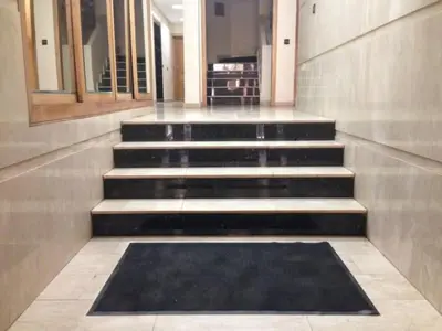 a set of stairs in a building with a black rug at Résidence journalière chic Casablanca in Casablanca