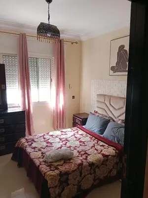 a bedroom with a large bed with pink curtains at La maison de rêve in Casablanca