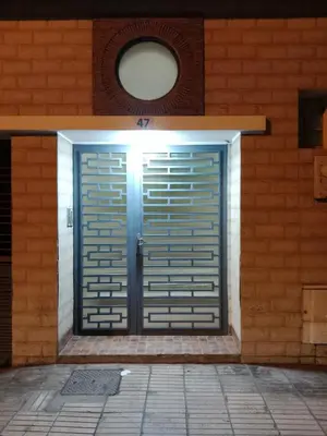 a metal door on a brick building at La maison de rêve in Casablanca