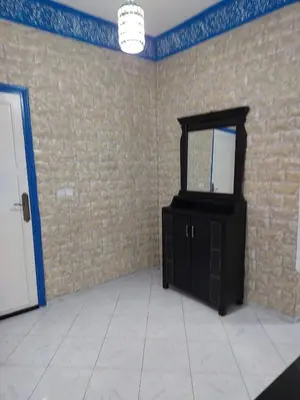 a room with a black cabinet and a brick wall at Dar Indigo in Temara