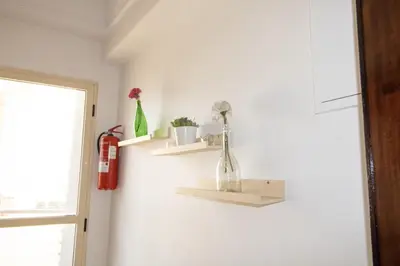 a room with two shelves on the wall with flowers at Horizon Mogador home in Casablanca
