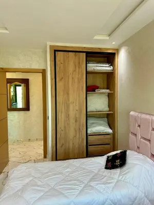 a bedroom with a closet and a bed in it at Appartement haut standing, 2 chambres - Mohammedia in Mohammedia