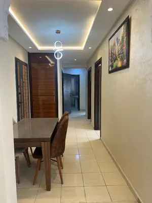 a dining room with a wooden table and chairs at appartement a 1 min de la plage in Casablanca