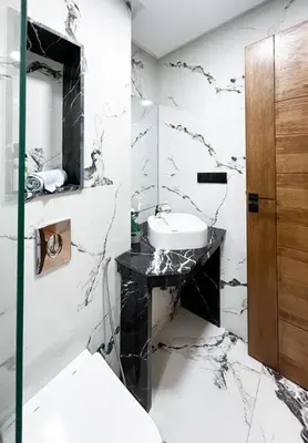 a black and white bathroom with a sink and a mirror at Appart familial cœur Casa in Casablanca