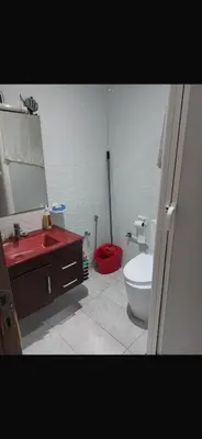 a bathroom with a red sink and a toilet at Marbella Beach apartement holiday 2 chambres,piscine et plage in Mansouria