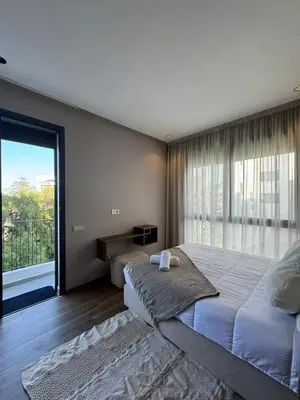 a bedroom with a large bed and a large window at Luxury Studio Oasis in Casablanca
