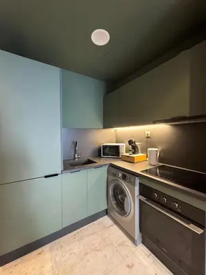 a kitchen with a washing machine and a washer at Luxury Studio Oasis in Casablanca