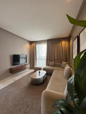 a living room with a couch and a tv at Luxury Studio Oasis in Casablanca