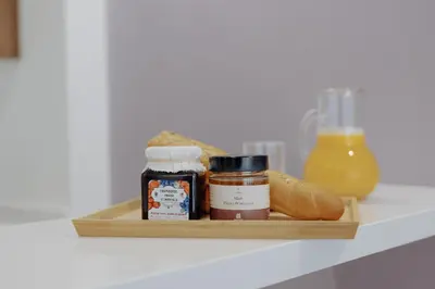a shelf with some food and a bottle of orange juice at The Shelter Residence by GoodMove - Bourgogne, Casablanca in Casablanca