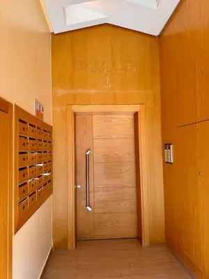 a wooden door in a room with wine racks at Bright Apt with Balcony, WiFi, Parking and Pool Resort in Bouznika
