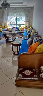 a row of beds in a room with a table at Al yakoute in Mansouria